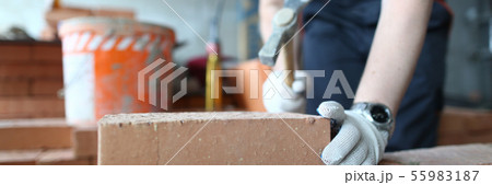 Skilled bricklayer putting red block Skilled bricklayer putting red block 55983187