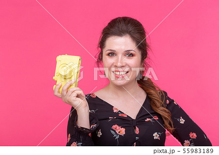 Photographing, glamour and vintage concept - young woman with retro camera is smiling Photographing, glamour and vintage concept - young woman with retro camera is smiling 55983189