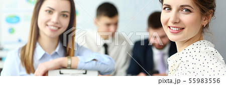 Young beautiful smiling clerk in office looking in camera Young beautiful smiling clerk in office looking in camera 55983556
