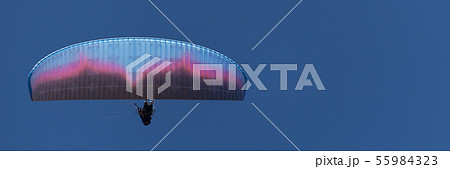 Paraglider tandem fly against the blue sky Paraglider tandem fly against the blue sky 55984323