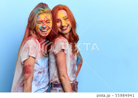 two friends take part in the smearing of colours two friends take part in the smearing of colours 55984941