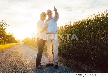 Senior couple enjoying an evening walk in the countryside 55985032