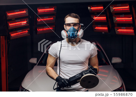 awesome young mechanic working with a polishing device awesome young mechanic working with a polishing device 55986870