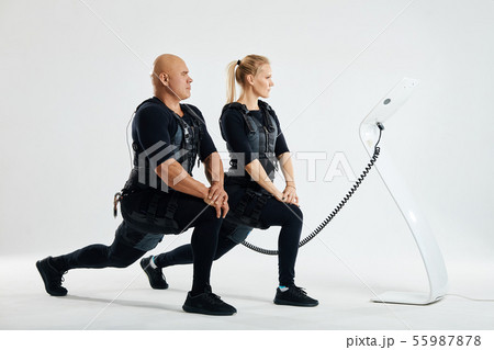 sport people in EMS costumes are doing exercises 55987878