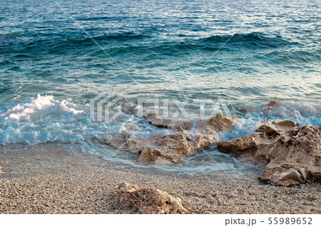 Rocky beach and crystal turquoise water of Ionian Sea in Albania. Calm and relaxing view Rocky beach and crystal turquoise water of Ionian Sea in Albania. Calm and relaxing view 55989652