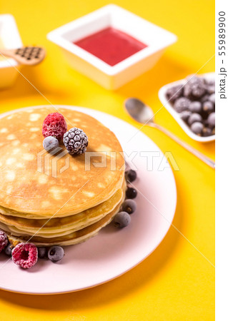 Pancakes on a bright yellow table 55989900