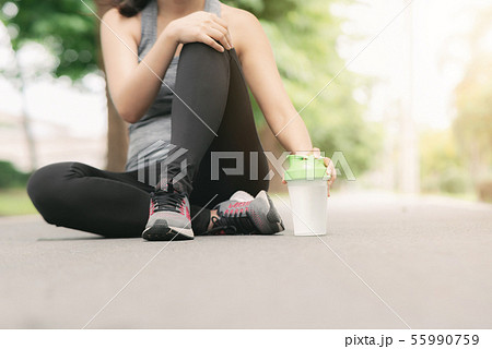Woman rest during jogging in the park Woman rest during jogging in the park 55990759