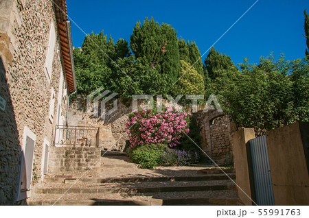 Stone house with staircase and flowers 55991763