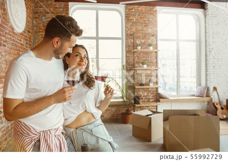 Young couple moved to a new house or apartment Young couple moved to a new house or apartment 55992729
