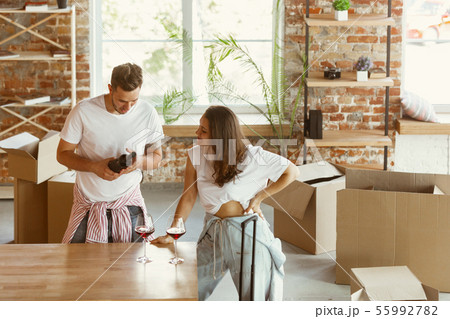 Young couple moved to a new house or apartment Young couple moved to a new house or apartment 55992782