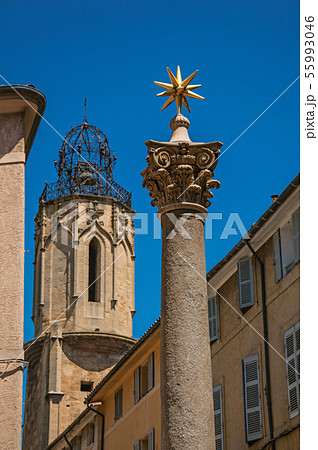 Column with golden star and bell tower in France 55993046