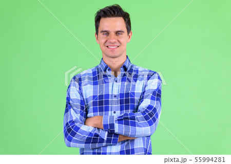 Happy young handsome hipster man smiling with arms crossed Happy young handsome hipster man smiling with arms crossed 55994281