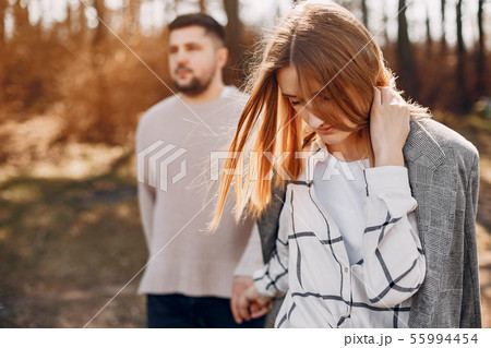 Beautiful couple spend time in a summer park Beautiful couple spend time in a summer park 55994454