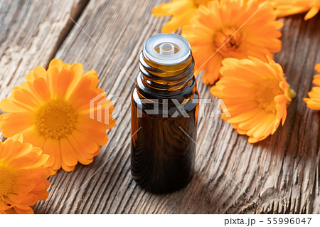 A bottle of calendula essential oil with calendula A bottle of calendula essential oil with calendula 55996047
