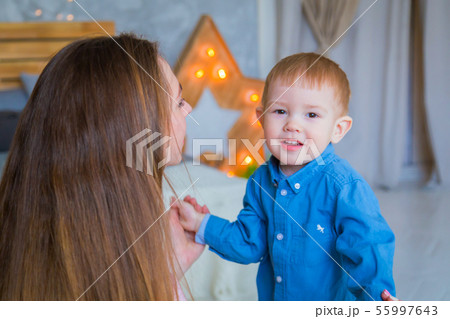 Happy young mother and her baby son playing togerher Happy young mother and her baby son playing togerher 55997643