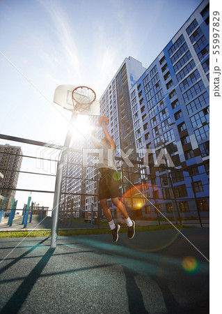 Basketball Player Jumping in Sunlight Basketball Player Jumping in Sunlight 55997829