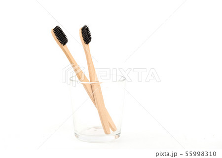Set of toothbrushes in glass isolated on white background. Bamboo eco-friendly. Zero waste Set of toothbrushes in glass isolated on white background. Bamboo eco-friendly. Zero waste 55998310