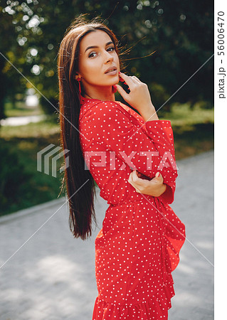 Elegant brunette in a summer city 56006470