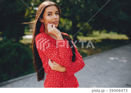 Elegant brunette in a summer city 56006473