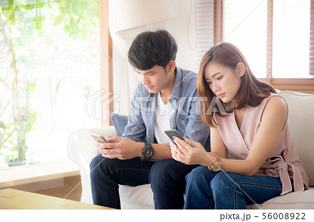 Young asian couple sitting on sofa with problem Young asian couple sitting on sofa with problem 56008922