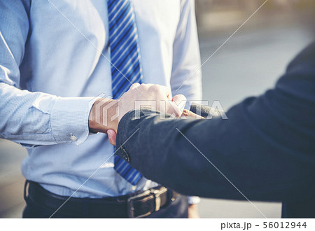 Team Business Partners shaking hands together to 56012944