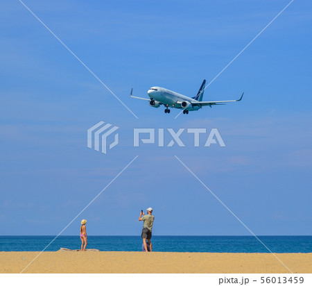 Airplane landing at Phuket Airport Airplane landing at Phuket Airport 56013459