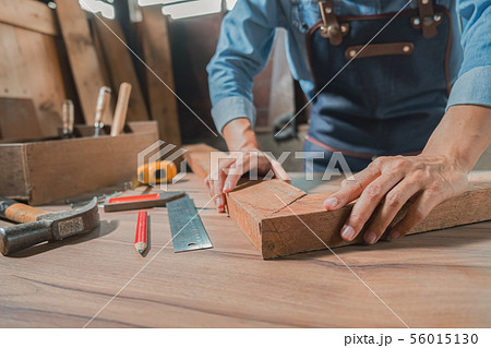 Carpenter working with equipment on wooden table Carpenter working with equipment on wooden table 56015130