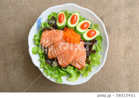 Raw Salmon sashimi with vegetable in ceramic bowl Raw Salmon sashimi with vegetable in ceramic bowl 56015431