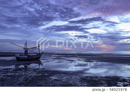 The morning sun light in the sea the boat on beach 56025978
