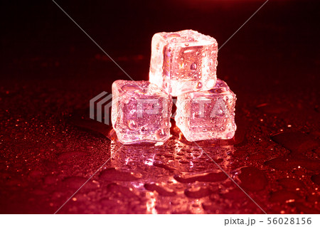 ice cubes on a reflections red light. ice cubes on a reflections red light. 56028156