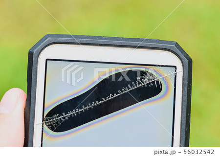 Close up broken screen and dead pixels mobile smartphone , Cracked smartphone in hand holding for 56032542