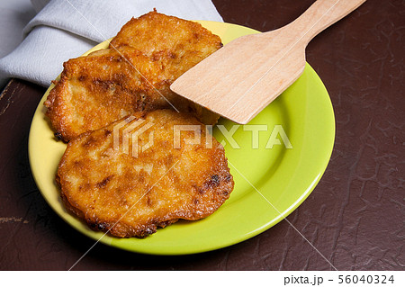 Potato pancakes with meat on green plate in 56040324