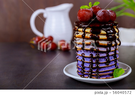 Beautiful pancakes with grape, chocolate glaze and Beautiful pancakes with grape, chocolate glaze and 56040572