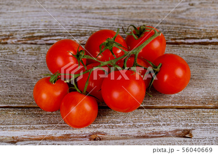 Tomatoes on the vine on rustic wooden background 56040669