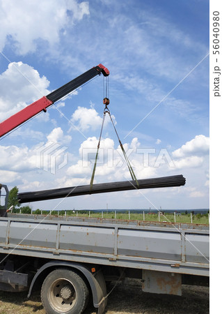 The truck crane in the field on the private land 56040980