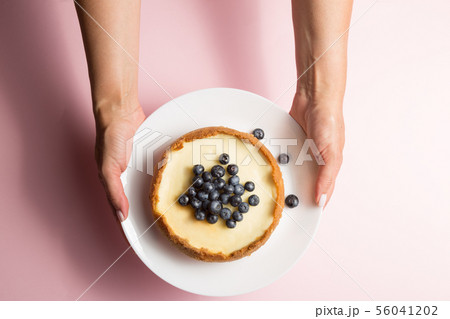 Top view of woman holding cheesecake with Top view of woman holding cheesecake with 56041202