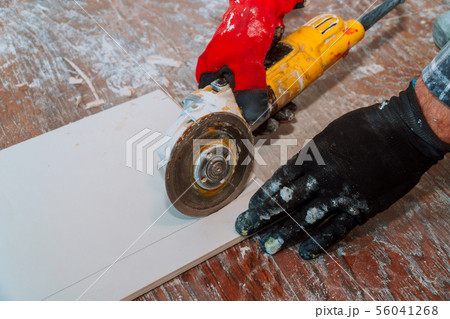 side grinder working on paving tile on building side grinder working on paving tile on building 56041268