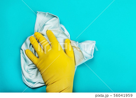 hand in a rubber glove holding a rag and wipes on a blue background hand in a rubber glove holding a rag and wipes on a blue background 56041959