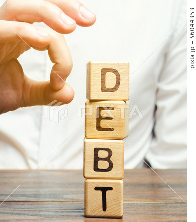 Businessman removes wooden blocks Businessman removes wooden blocks 56044353