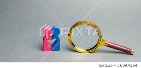Couple of lovers standing near a magnifying glass. Couple of lovers standing near a magnifying glass. 56044564