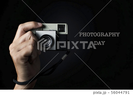 man with a film camera and text photography day. 56044791