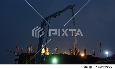 Construction crane truck working on structure at 56044955