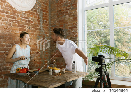 Young couple cooking and recording live video for vlog and social media Young couple cooking and recording live video for vlog and social media 56046696