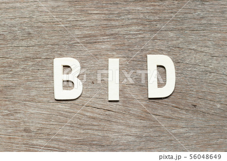 Alphabet letter in word bid on wood background 56048649