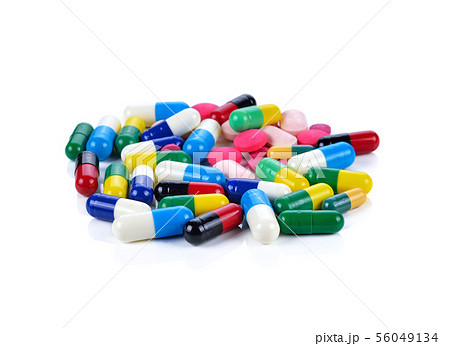 Colored pills, tablets and capsules on a white 56049134