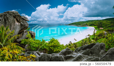 Picturesque panoramic shot of Grand Anse, La Digue island, Seychelles. Huge granite rock formation Picturesque panoramic shot of Grand Anse, La Digue island, Seychelles. Huge granite rock formation 56050479