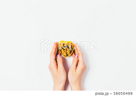 Woman's hands holding heart-shaped package 56050499