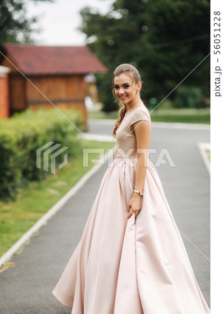 Young stylish model poses to photographer outside 56051228