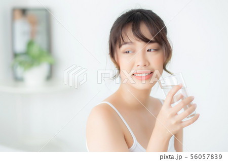 Beautiful portrait young asian woman drink water Beautiful portrait young asian woman drink water 56057839