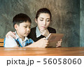 Asian,Woman and little boy sitting, playing tablet 56058060